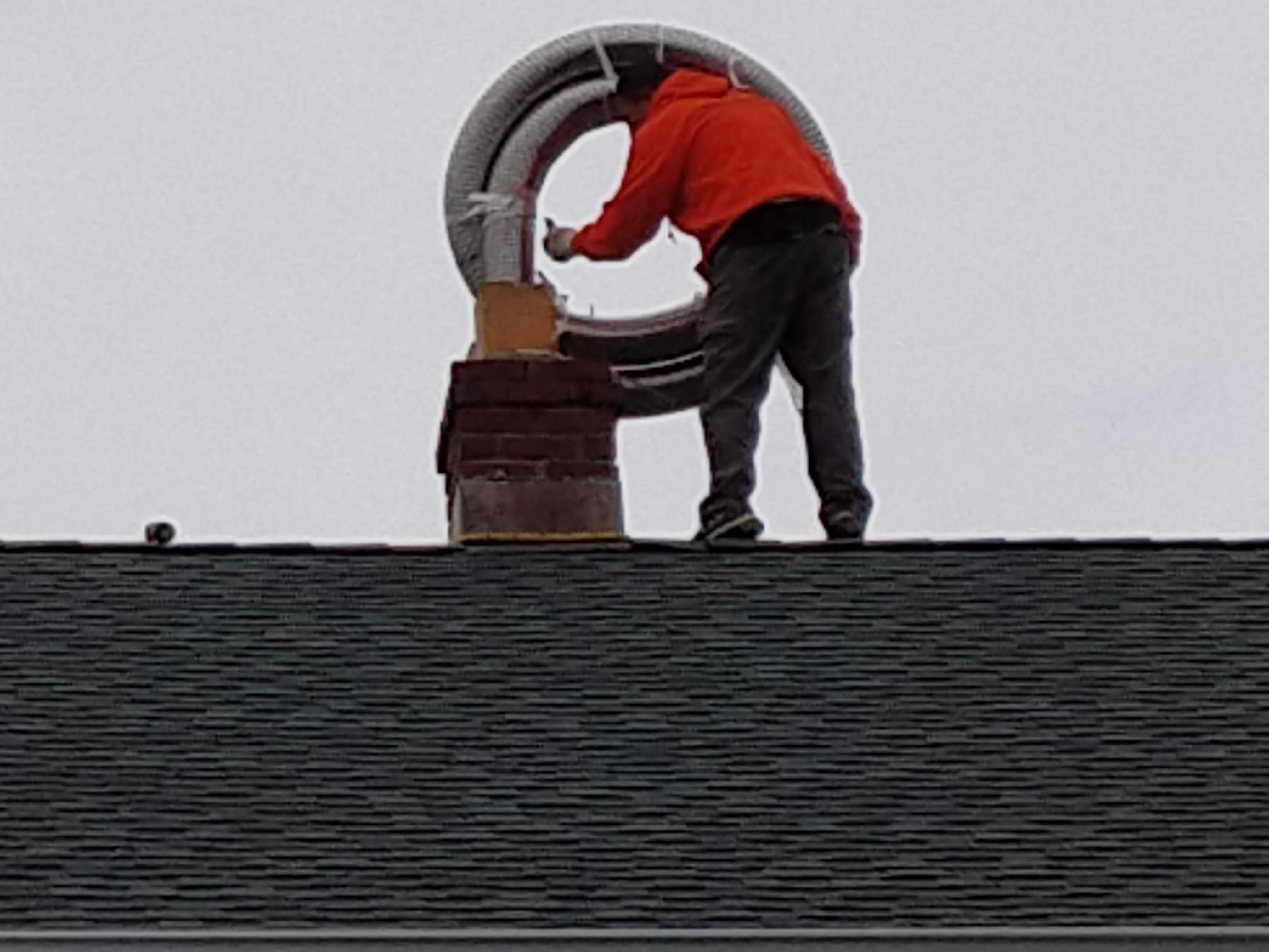 Flexible stainless chimney liner being installed in Westbury, New York